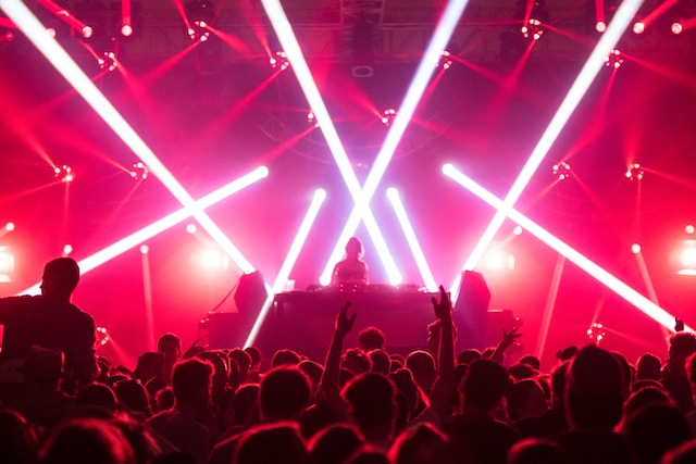 silhouettes of people dancing in a night club with pink neon lights